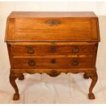 An early George III oak bureau, circa 1760, in a Queen Anne design, fall front slope enclosing an