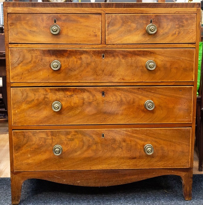 A George III mahogany and satinwood strung chest of two short over three long graduated drawers,