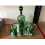 An Italian green glass spirit decanter set on a tray, with silvered decoration (8)