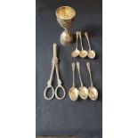 A white metal double ended measure six silver fancy coffee spoons and a pair of plated grape