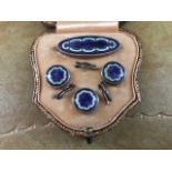 A circa 1920's cased four piece silver and enamel button/brooch set