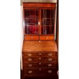A George III mahogany Bureau Bookcase, Circa 1820 moulded cornice satinwood strung inlay on a