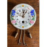 A Late 19th Century miniature wall timepiece with floral enamel dial.