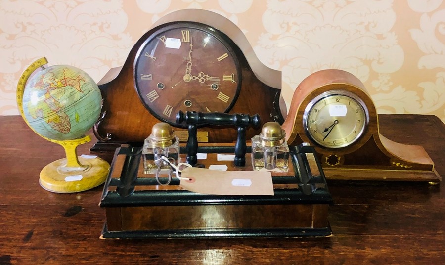 A 20th century oak inkwell; globe; two similar mantle clocks.