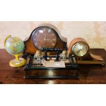 A 20th century oak inkwell; globe; two similar mantle clocks.