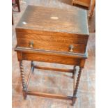 An early 20th Century oak cutlery canteen on stand, rectangular shape revealing a stainless steel