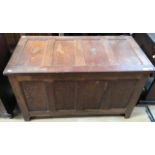 A traditional oak chest, having a four panelled top, four panelled front, single storage section,