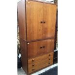 A 1970s teak tallboy, having two doors over three drawers, possibly G Plan, together with a two door