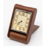 A Jaeger-LeCoultre leather-cased travel clock, with eight day movement in tan folding case