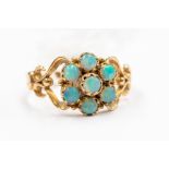 A Victorian opal cluster 9ct gold ring, comprising a flower cluster of round opals to open scroll