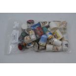 A collection of assorted hand painted thimbles, some signed 'D Wilson', depicting various scenes and