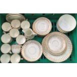 A late Victorian gilded tea set comprising a milk jug, slop bowl, ten cups, eleven saucers, eleven