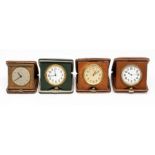 Four leather and crocodile cased travel clocks including one by Mappin, the Swiss eight day '