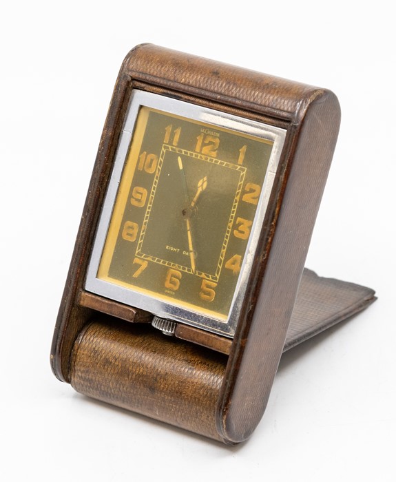 A Jaeger-LeCoultre leather-cased travel alarm clock, with eight day movement in patterned tan