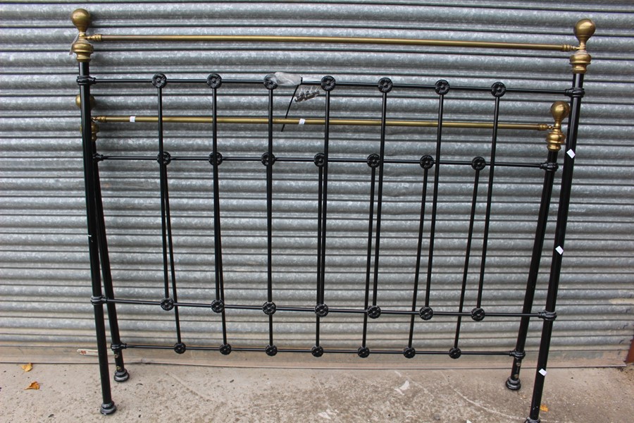 A large tubular steel black double bed frame