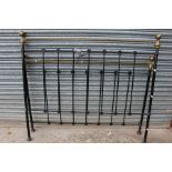 A large tubular steel black double bed frame