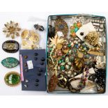 A collection of costume jewellery to include an early 20th Century hat pin with gilt decoration,
