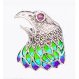 A silver and pliqué a jour enamel brooch/pendant in the form of an eagle, ruby cabochon set eye with