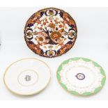 A group of three porcelain plates, to include: An armorial plate with a central crest for the