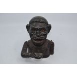 An early 20th Century cast iron black boy money box