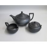 A Wedgwood Black Basalt Tea pot, Milk Jug and Covered Sugar Box   Shape 146 Date: Mid 20th century