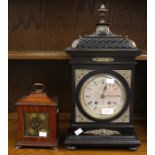 Ebonised early 20th Century German mantle clock with silvered face and Roman numerals, along with