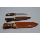 Three recent Bowie type fixed blade knives, the first by Bora with wood grips, the 7" blade engraved