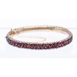 A Victorian Bohemian garnet and paste set gilt metal bangle, comprising two rows of stones, width