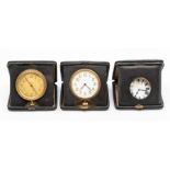 Three leather cased travel clocks, the eight day 'pocket watch' movements in square cases, 10.5cm (