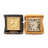 Two Asprey leather cased travel clocks, the eight day 'pocket watch' movements in square tan