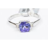 A tanzanite and diamond 14ct white gold ring, comprising a cushion shaped tanzanite, weight