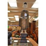 A 20th Century Chinese carved and painted wood altar figure of a Buddha, holding a pot, 63cm high