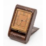 A Jaeger-LeCoultre snakeskin cased travel clock, with eight day movement in dark brown folding case,