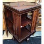 An Edwardian style mahogany revolving bookcase, of square section, two-tier form, raised on castors,