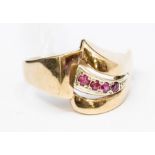 A 9ct gold and ruby ring, asymmetric mount, curved raised setting of  four round cut rubies, width