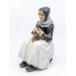 A Royal Copenhagen porcelain large figure of Armager girl sewing designed by Lotte Benter, no: 1317