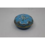 A French enamel box, of compressed globular form and decorated with flower sprays within black and