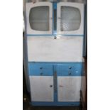 A circa 1950's light blue and white kitchen cabinet with original glass and compartments to the
