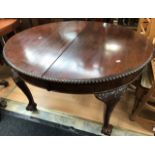 A reproduction Queen Anne mahogany wind out table with one leaf and four matching chairs, with
