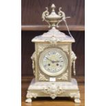 A French style brass mantel clock, probably 19th Century, with white numerals, the top with an urn