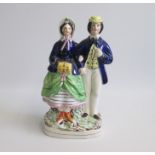 A Staffordshire Portrait figure of Princess Alice and Louis of Hesse standing on a gilt lined