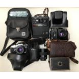Four  vintage cameras : Zenit-E, Olympus OM10, Kodak EK 160 instant,  EHO box camera, along with a