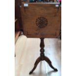 A 19th Century tilt top mahogany tripod table, having a square sectioned top, turned column,