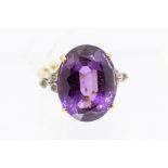 An amethyst, diamond dress and 18ct gold ring, the claw set large oval cut amethyst measuring