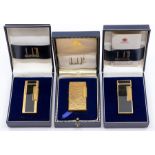 Three cased Dunhill cigarette lighters, 2nd half 20th Century, the first yellow metal with