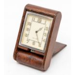 A Jaeger-LeCoultre leather-cased travel clock, with eight day movement in dark tan folding case