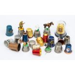 Thimbles; A collection of assorted white metal and base metal thimbles, of various designs, some