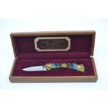 A recent Buck custom pocket lock knife, with folding 3" blade, the brass handle inlaid with wood,