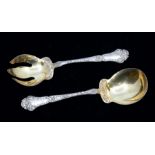 A pair of Art Nouveau style probably American sterling silver salad servers, with foliage embossed