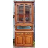 A Victorian walnut bookcase, fitted with two glazed doors to upper section, raised on columns, the